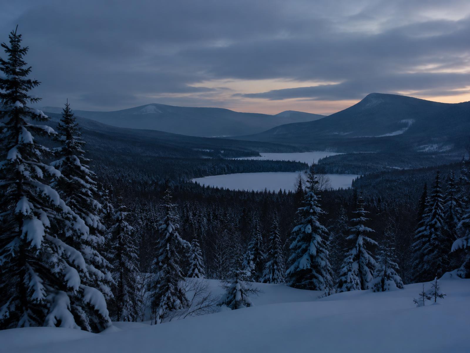Snow-covered valley at dusk